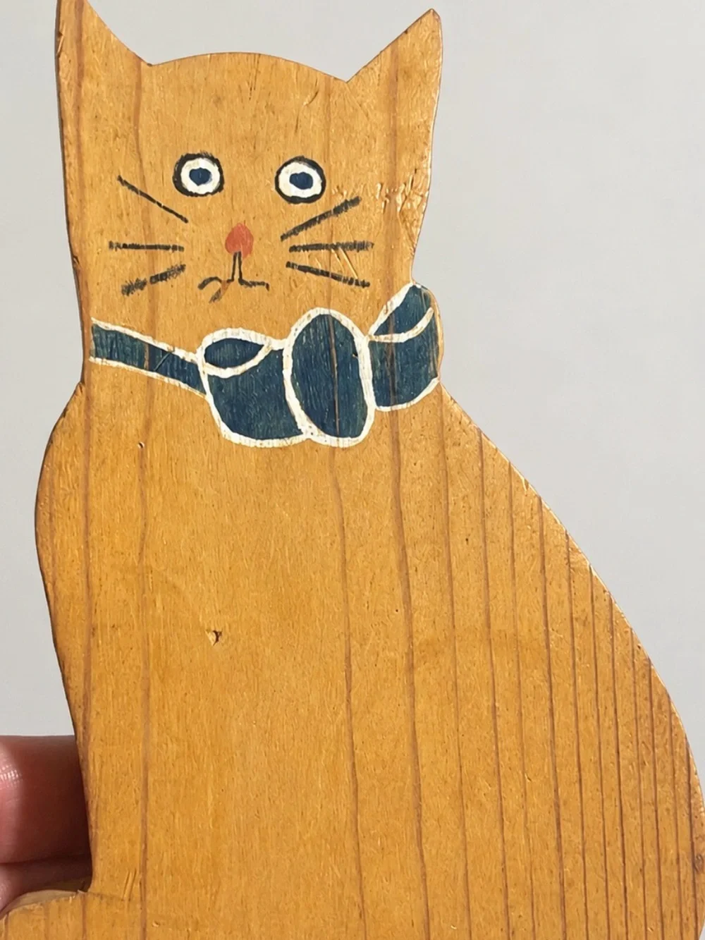 This is a vintage hand-painted wooden sitting cat figurine by folk artist C Grif